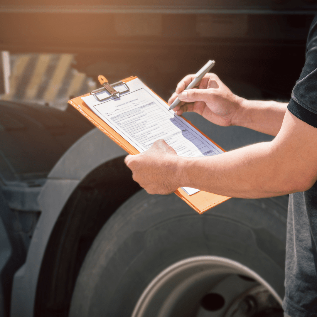 man writing on a clip board